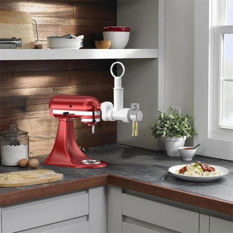 KitchenAid pasta maker attachment mounted on stand mixer with feed tube and handle