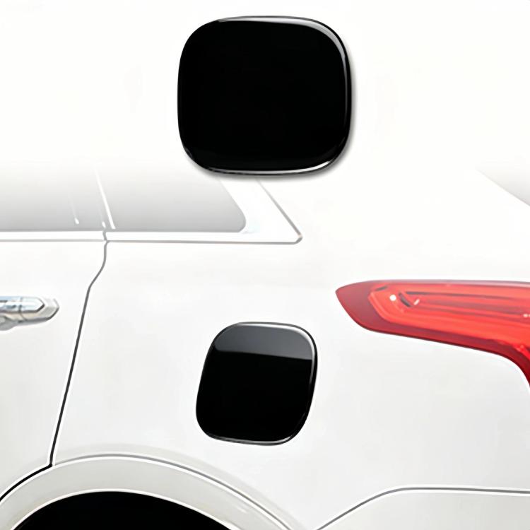 Glossy black fuel door sticker, curved square shape on white vehicle