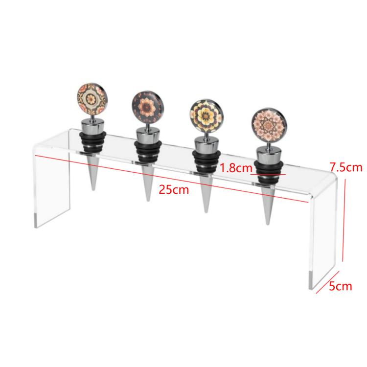 Clear acrylic wine stopper rack with four stoppers and visible size markings