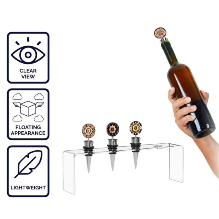 Clear acrylic wine stopper display stand with four stoppers; bottle held nearby