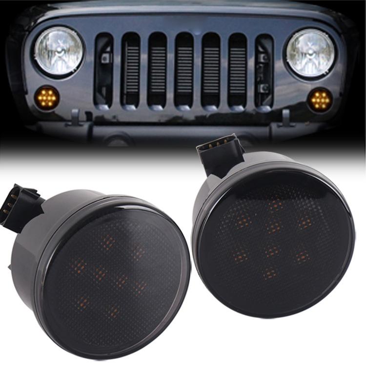 Two amber LED grille turn signal lights with dot pattern lens and black round housings
