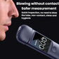 Portable breath alcohol tester held near mouthpiece, screen showing digital reading