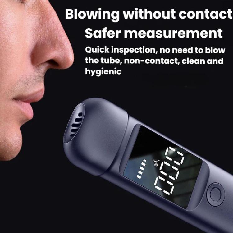 Portable breath alcohol tester held near mouthpiece, screen showing digital reading