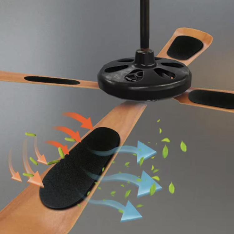 Black activated carbon air filter pads placed on a ceiling fan blade