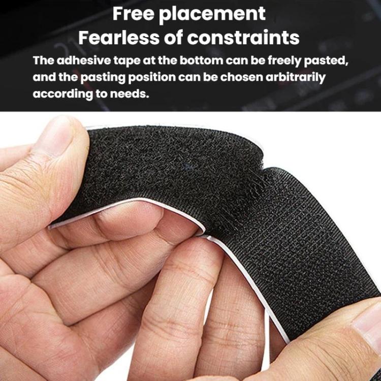 Black car charger adhesive mounting pad with curved edge, held by hand