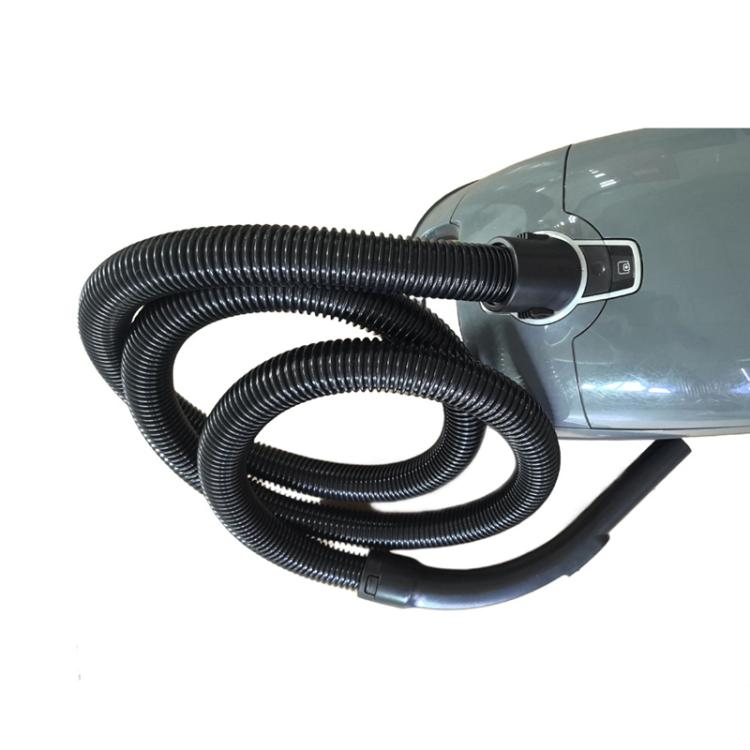Curved vacuum hose and nozzle handle attached to vacuum inlet