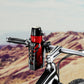 Black bottle cage with LED-lit holder on a bicycle frame near a bottle