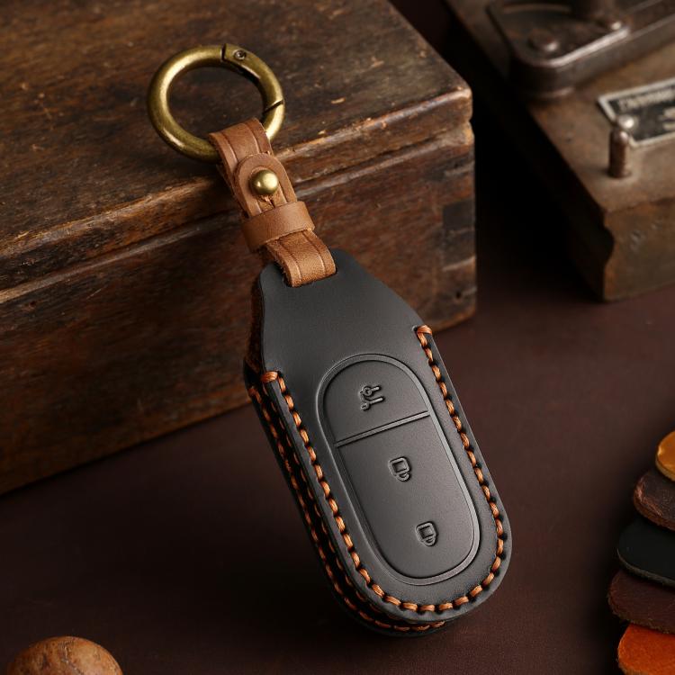 Dark gray genuine leather car key cover with tan strap and stitched oval key fob panel