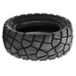 Black off-road tubeless scooter tire with chunky tread pattern and wide sidewall