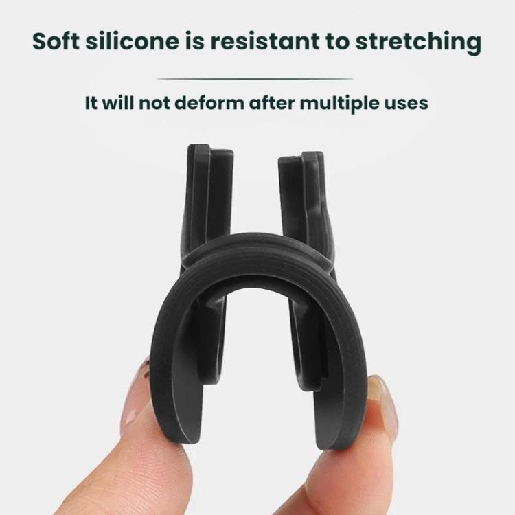 Single black silicone door limiter cover held in hand; oval body with square opening.