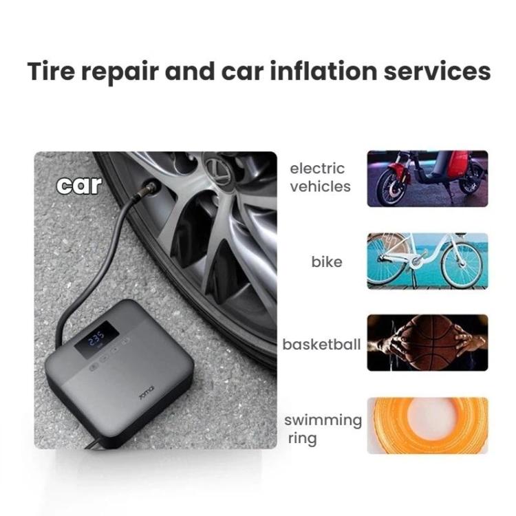 Compact tire inflator on the ground with nozzle and accessory set in view