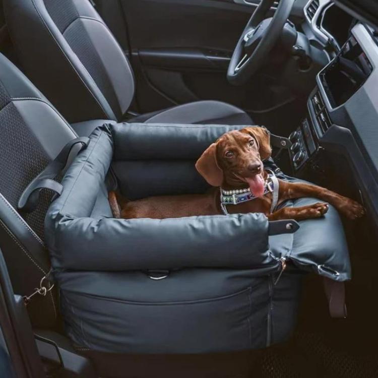 Dark blue pet car seat bed with padded walls and buckles, brown dog lying inside