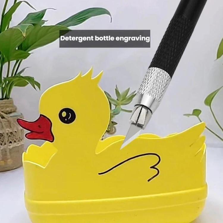Black carving knife with metal blade tip held above a decorative container