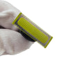 Electric shaver blade head close-up with yellow perforated guard and silver teeth
