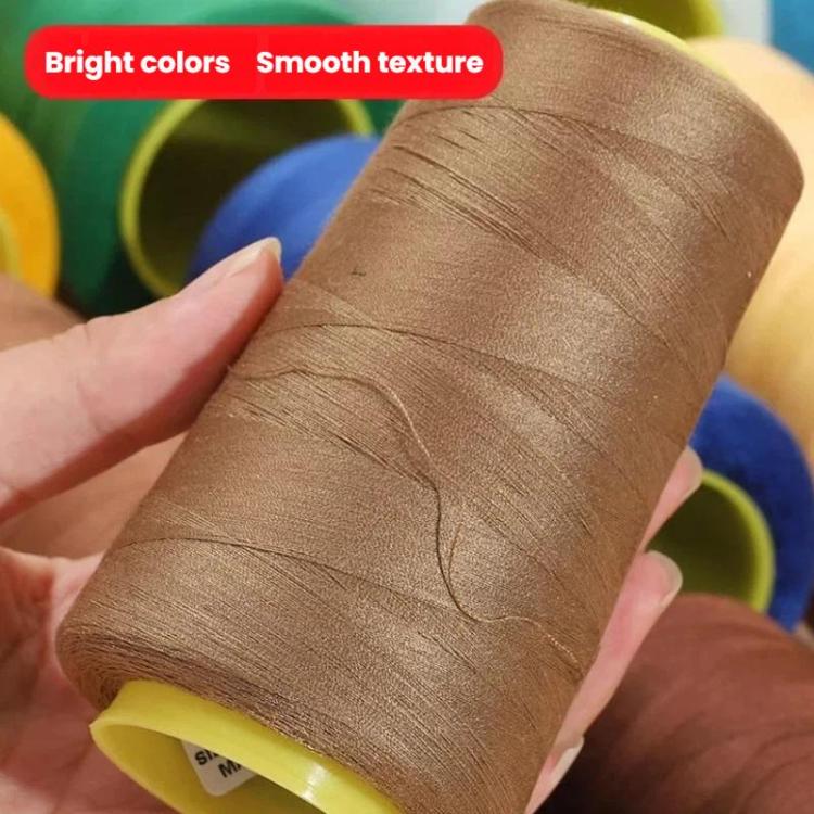 Brown fine polyester sewing thread spool on yellow bobbin, close-up