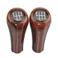 Pair of dark brown wood-grain 6-speed gear shift knobs with black grips
