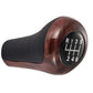 Dark brown wood-grain gear shift knob with black leather base and 6-speed dial