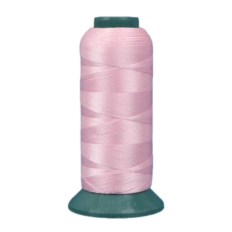 Nylon sewing thread spool, pink 3-strand thread on green base.