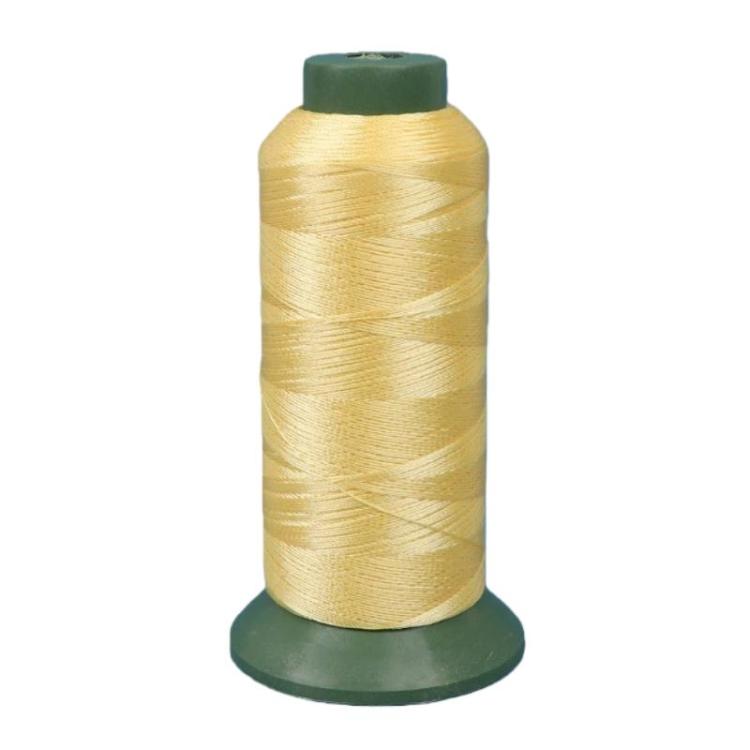 Nylon sewing thread spool, yellow 3-strand thread on green base.