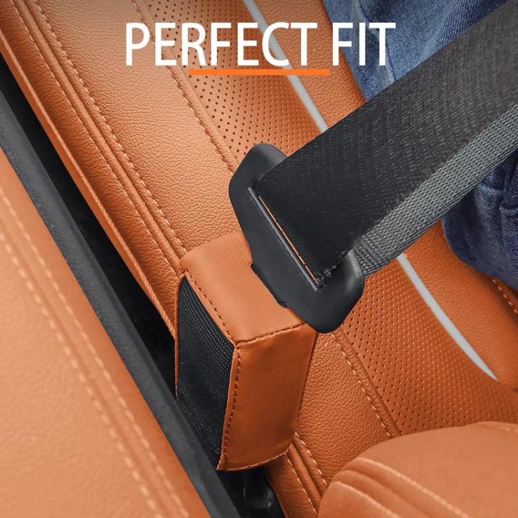 Orange and black car seat belt buckle protector cover on seat belt.