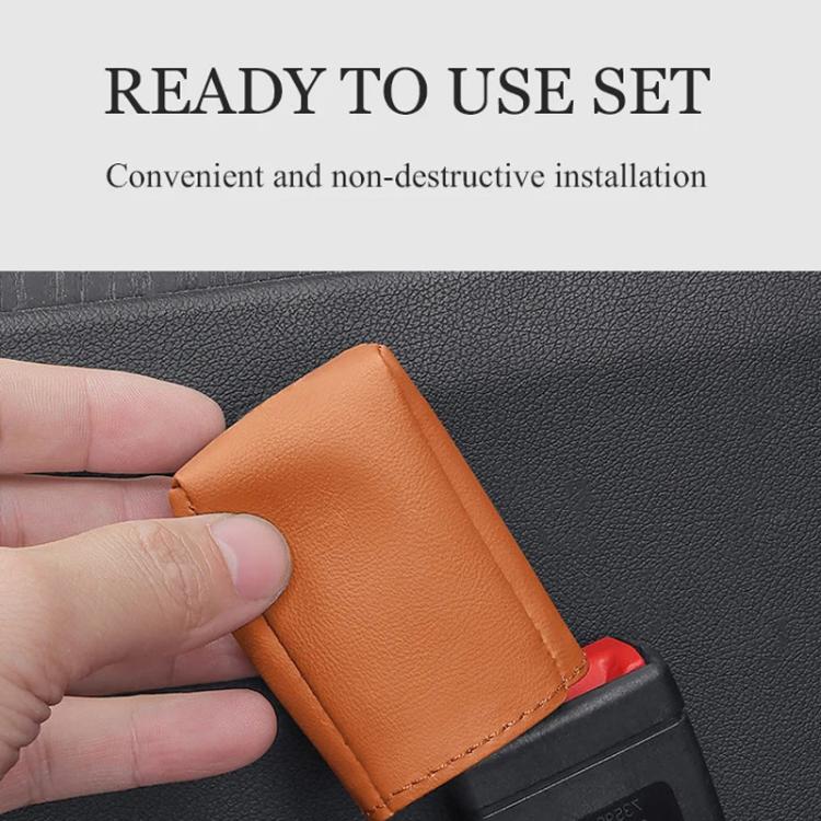 Orange leather car seat belt buckle protector cover held in hand.