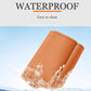 Orange leather car seat belt buckle protector cover with water droplets on surface.