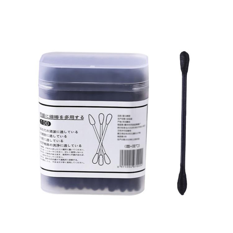Disposable double-ended cotton swab, black swab shown beside clear plastic box