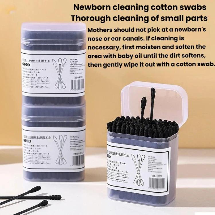 Stacked boxes of disposable cotton swabs with black spiral tips and loose swab