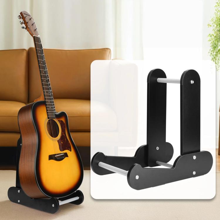 Vertical guitar stand with black frame holding an acoustic guitar