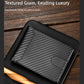 Black carbon-fiber bi-fold card wallet with stitched edges and ID window