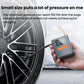 Portable tire inflator held in hand next to a car wheel with mounted air hose