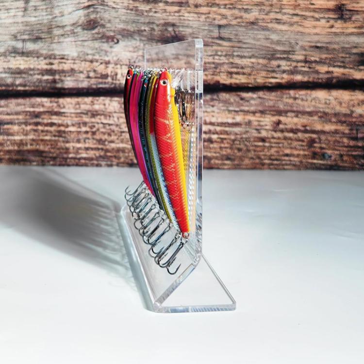 Angled clear acrylic lure display stand showing lures hooked on front pegs
