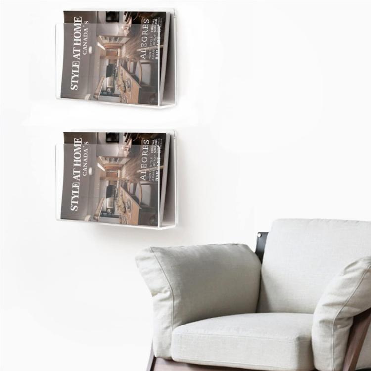 Two wall-mounted clear acrylic magazine holders mounted on the wall
