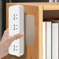 Hand pressing a clear double-sided adhesive pad onto an outlet cover