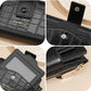 Black textured card wallet detail: logo badge, card slots, and gold zipper pull