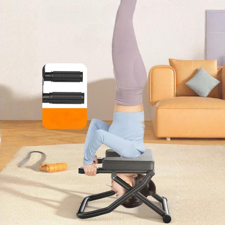 Foldable yoga inversion bench with gray pads and black frame, used for inversion exercise