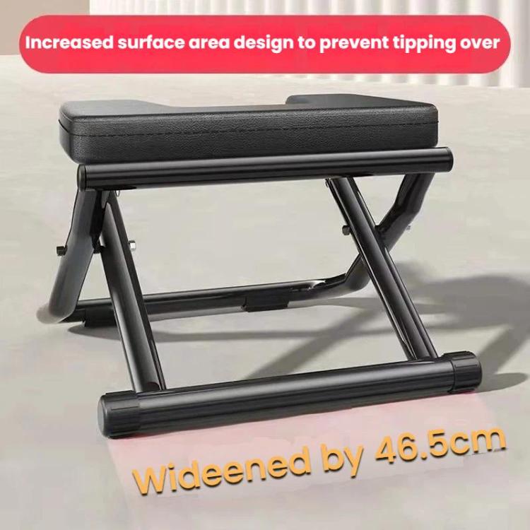 Foldable yoga inversion bench showing wide gray padded platform and black support frame