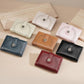 Set of women’s short wallets in multiple colors, perforated leather with zipper