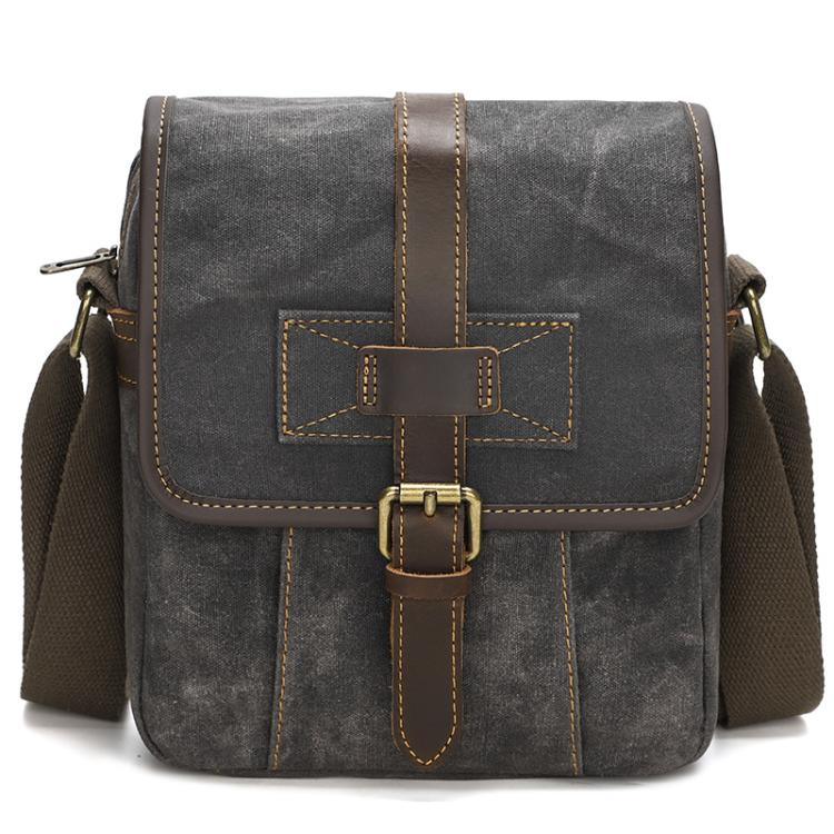 Deep gray waxed canvas crossbody bag with leather cross strap and front buckle