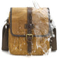 Dusty yellow waxed canvas crossbody bag with cowhide-style overlay and front buckle