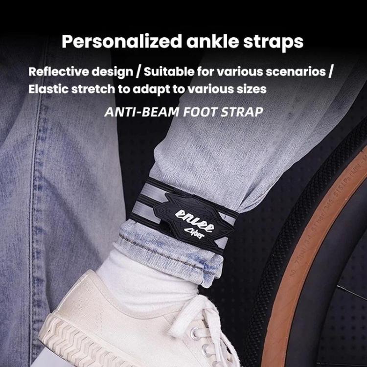 Reflective ankle strap worn over jeans near a sneaker, black and gray stripes