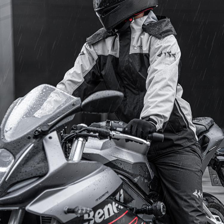Black motorcycle rain suit on a rider holding the handlebars in rainy weather
