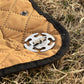 Stainless steel rope clip on tan fabric edge with black cord