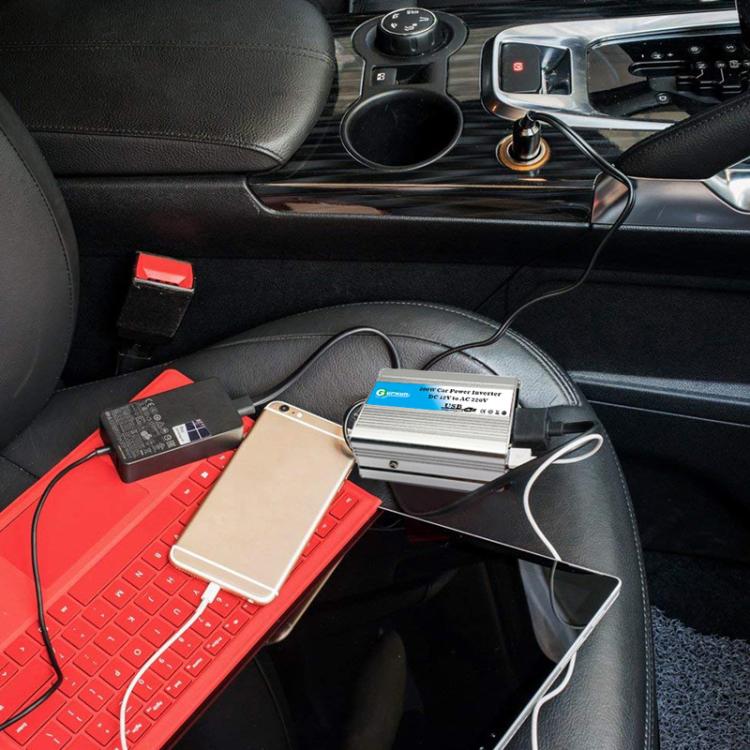 Aluminum car power inverter with cables on car seat, ready to power devices.