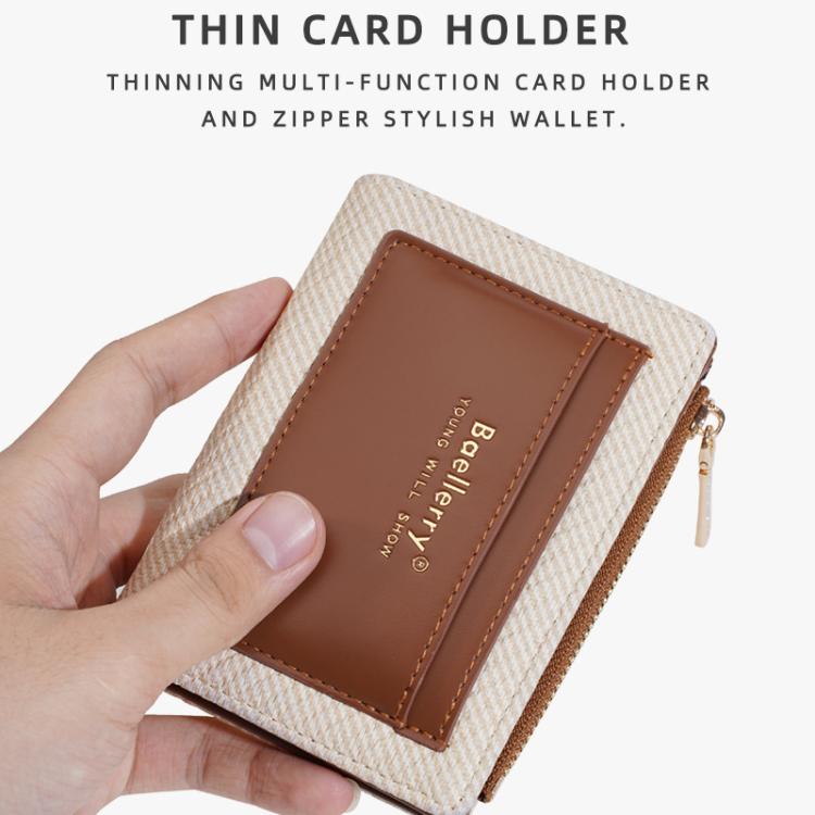 Brown compact zip card wallet held in hand, featuring a front card pocket.