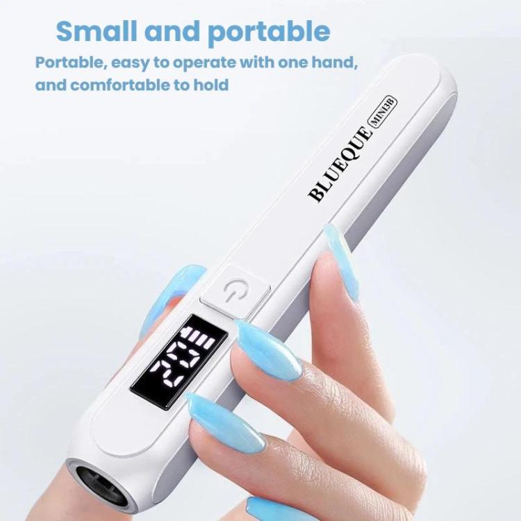 White handheld LED nail curing lamp held in hand with digital display and tip