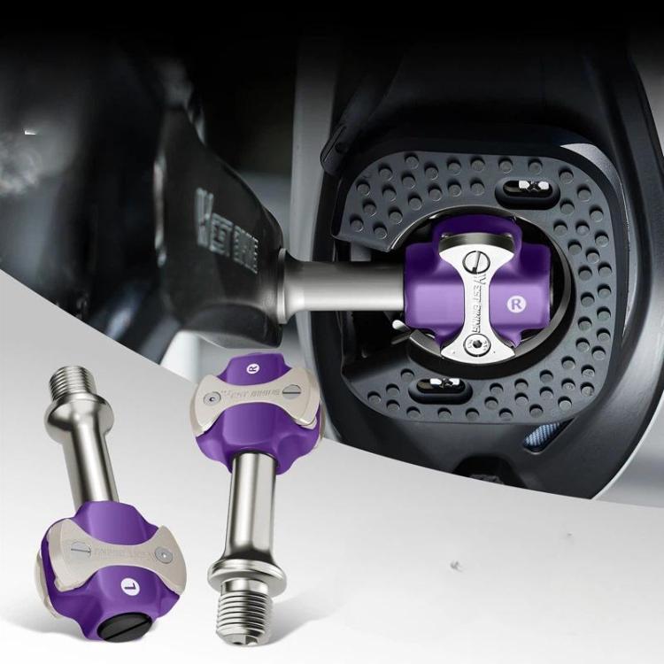 Purple bicycle lock pedal on a bike crank with black perforated pedal housing