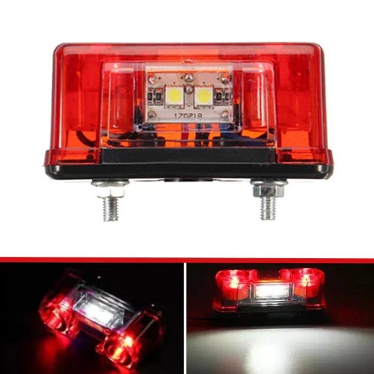 Waterproof LED license plate light with red translucent cover, visible LED circuit, and mounting bolts