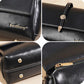 Close-up of black waxed leather crossbody bag with flap hardware and stitched edges