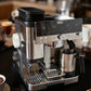 Bean hopper extension installed on a stainless espresso machine with black ridged top